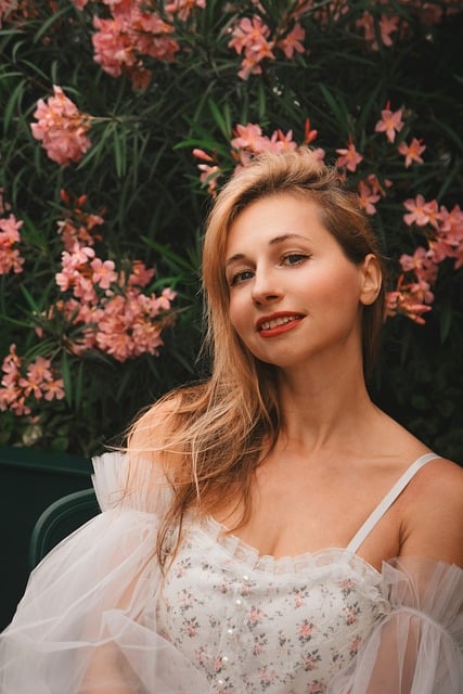 Smiling woman wearing elegant sage green midi dress outside a boutique storefront