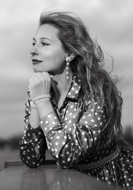 Navy polka dot tea dress with vintage-inspired collar and puff sleeves